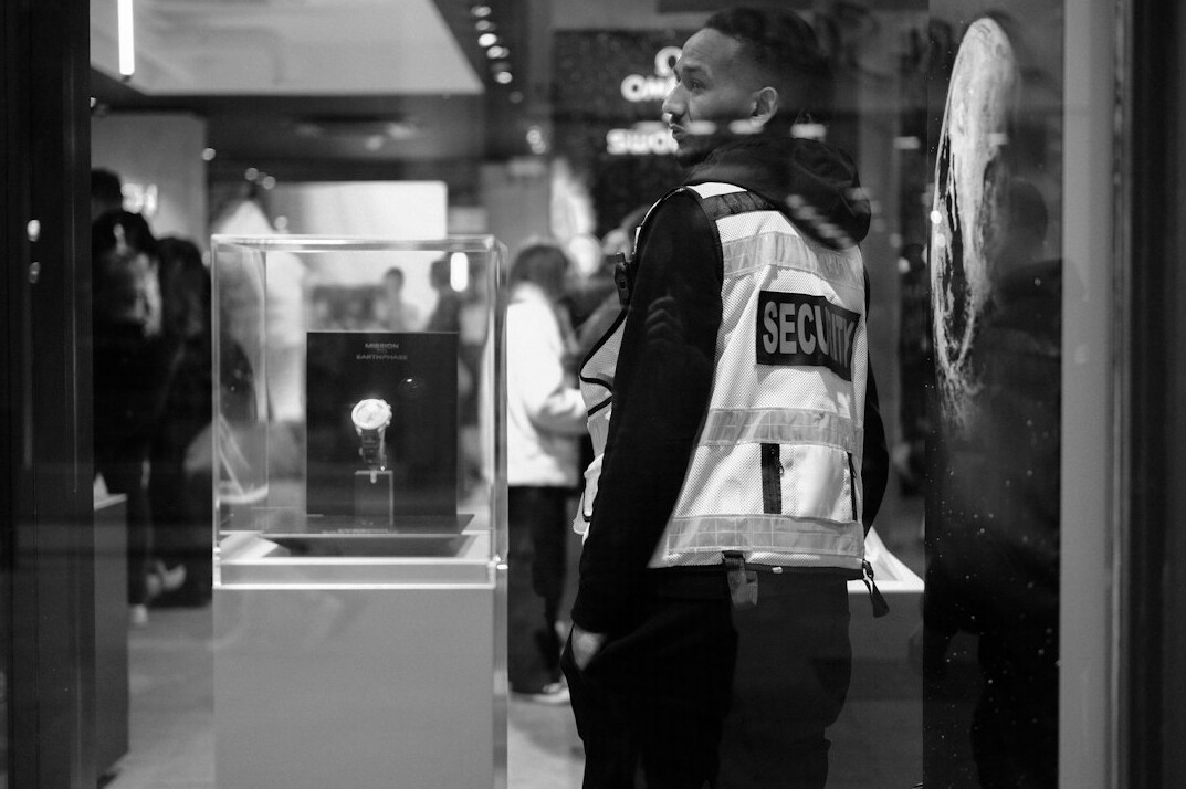 store security guard watching crowd